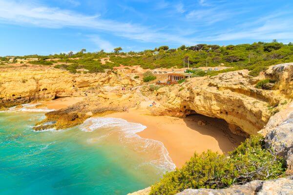 albandeira portugal beach yellow sand clear blue waters