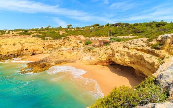 albandeira portugal beach yellow sand clear blue waters
