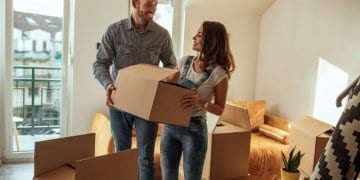 Couple Moving House, holding boxes