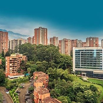 a park with buildings all arround mad eof bricks, in medellin colombia