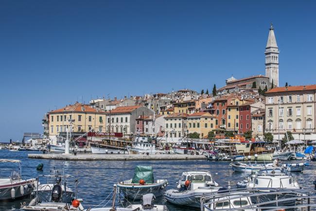 ports in the coast of Rovinj, Croatia with houses, boats in the sea.