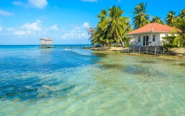 Beachside bungalows in Belize, one of the best places to enjoy a tropical climate