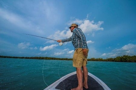 A man fly fishing in Belize