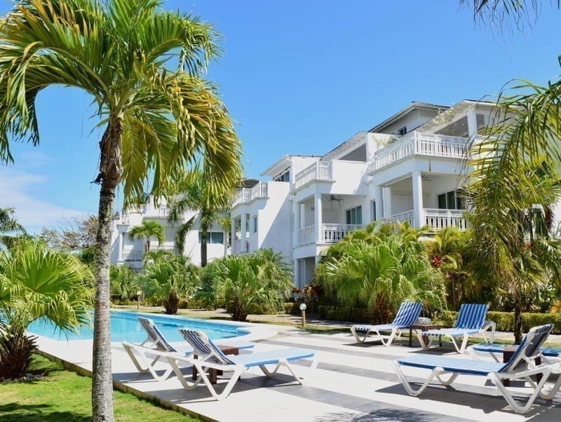 Holiday apartment with green vegetation and blue skies on background