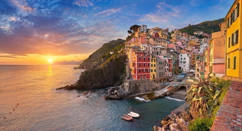 Sunset view of Riomaggiore, Riviera de Levanto, Cinque Terre, Liguria. expats in italy