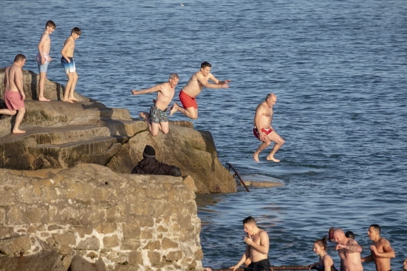 People jumping into the sea at Forty Foot during Christmas traditional swim.