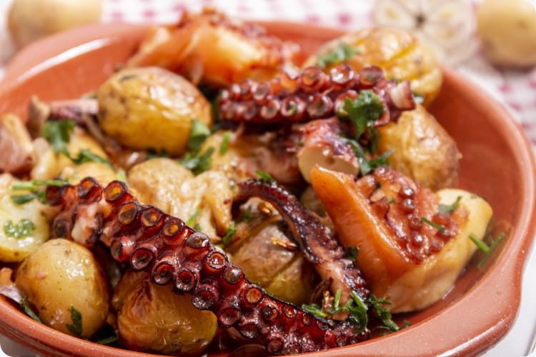 Grilled octopus with potatoes, garlic and salsa.