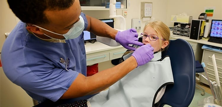 Child receiving health care in portugal at the dentist