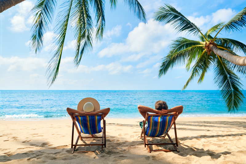 couple relaxing on beach new life overseas
