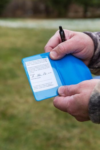 Deer hunter holding his completed deer license