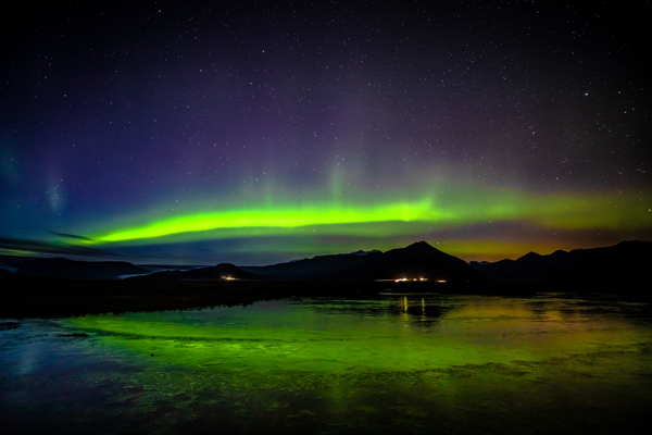 northern lights over a lake in iceland