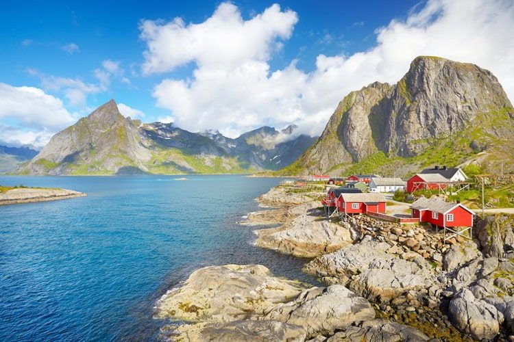 Traditional red wooden fishermen`s huts rorbu, Lofoten Island landscape, Norway