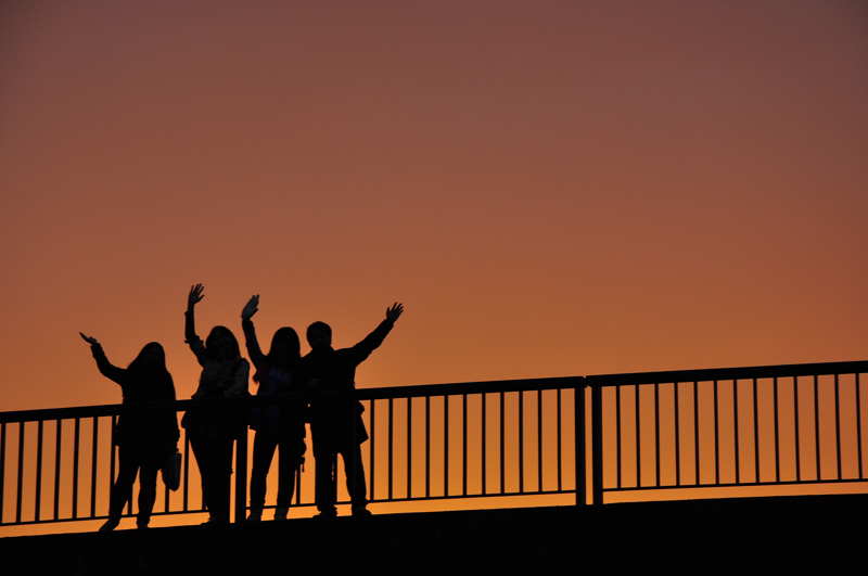 group of people waving goodbye