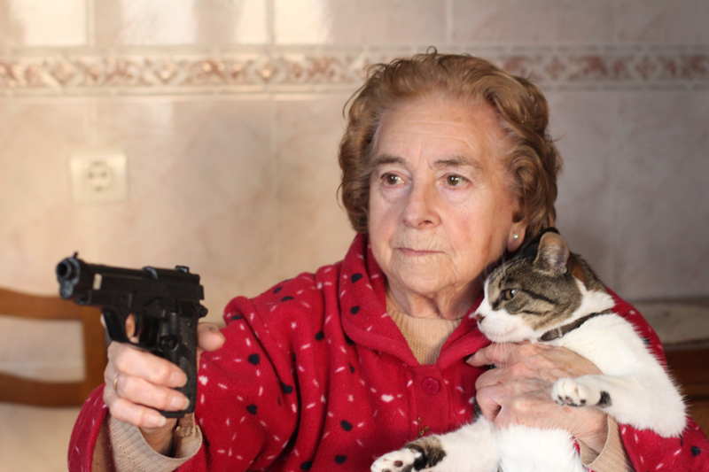lady with gun protecting her cat