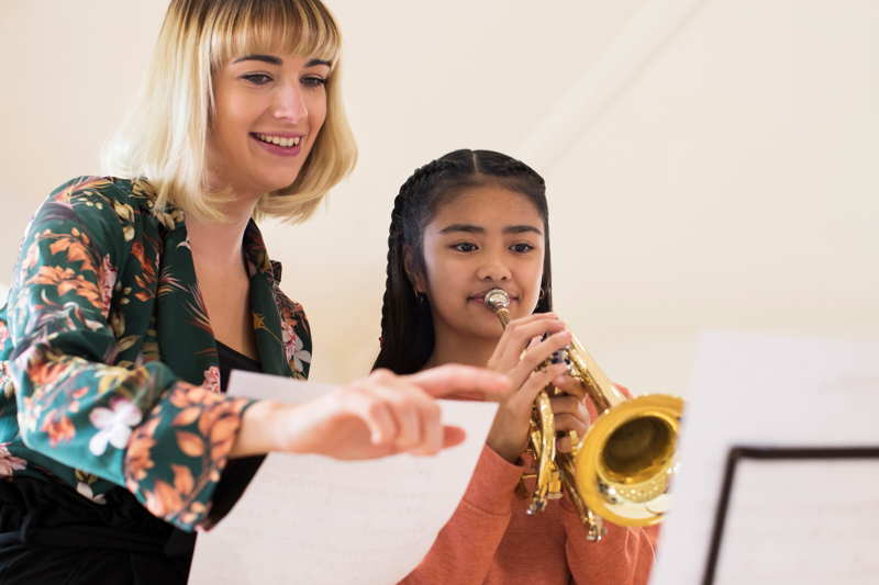 lady teaching music to a student