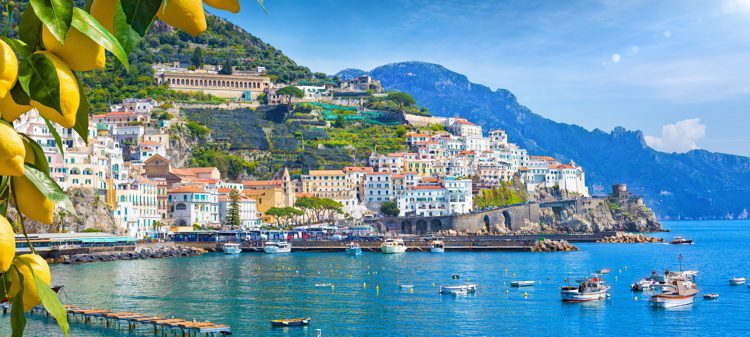 Panoramic view of beautiful Amalfi on hills leading down to coast, Campania, Italy.