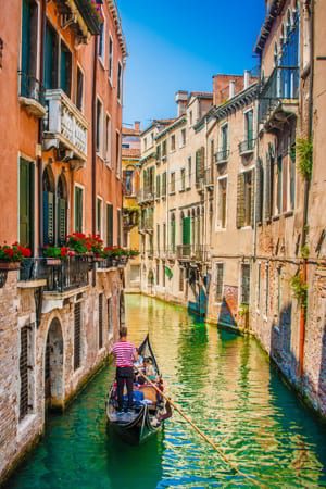 Beautiful scene with traditional gondola on a canal in Venice, Italy