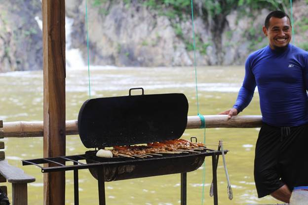 A man barbecuing meat