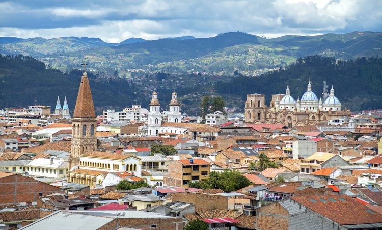 View of the city of Cuenca, Ecuador, with its many churches and rooftops, on a cloudy day