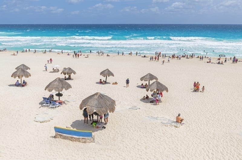 Tourist and local Mexican people on Playa Delfines