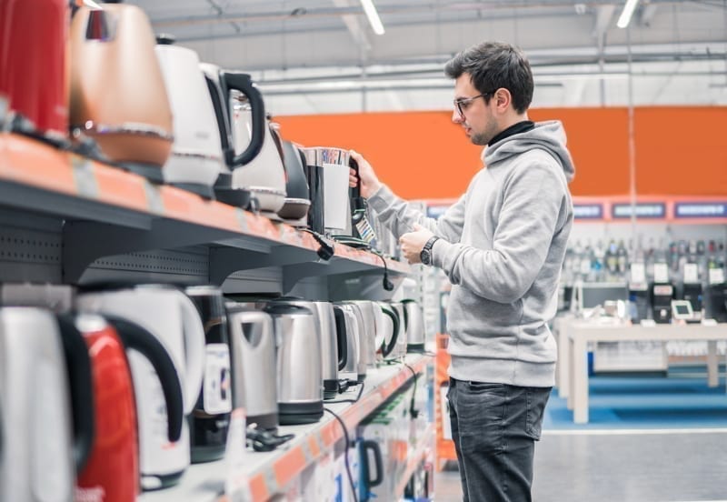 Man shopping for appliances. 