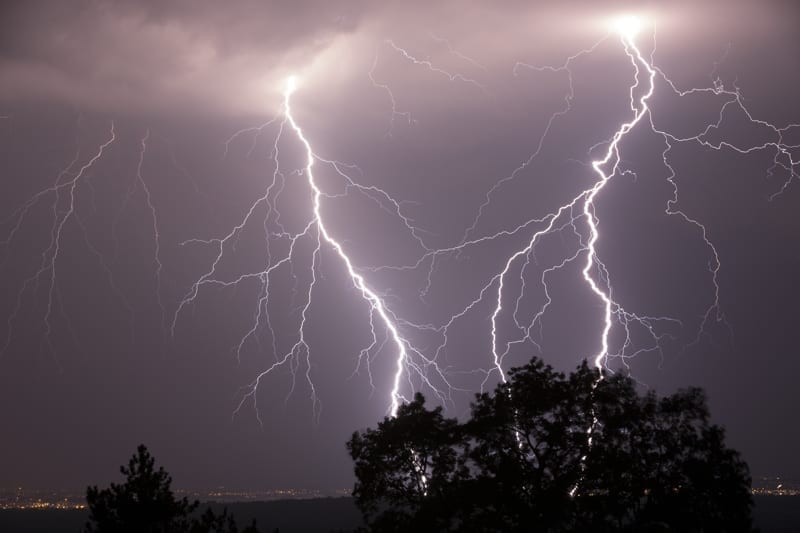 Night shot of stunning lightning strikes over non-urban landscape. 