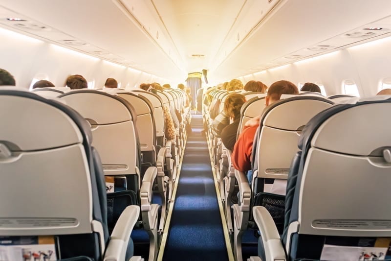 Commercial aircraft cabin with rows of seats down the aisle. Panama vs Belize