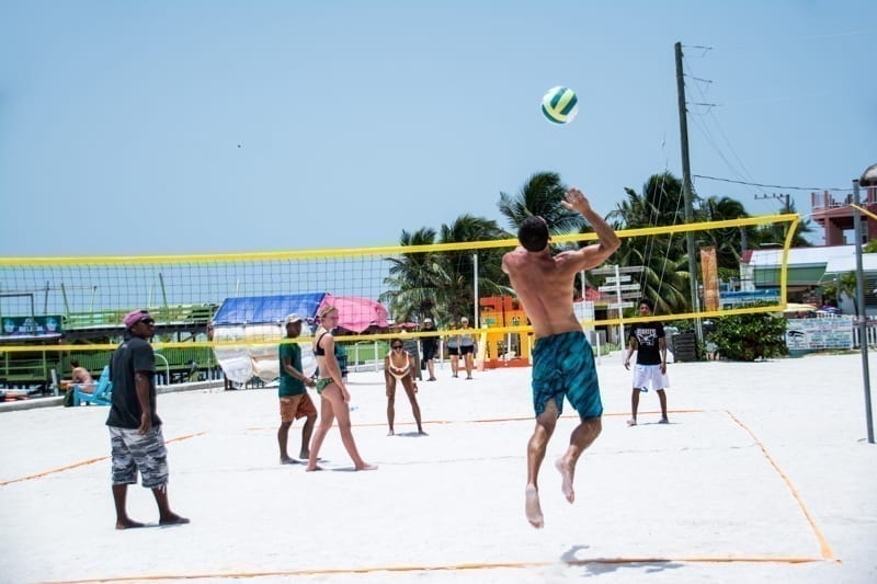 A game of pickup beach volleyball on the island of Caye Caulker, Belize.