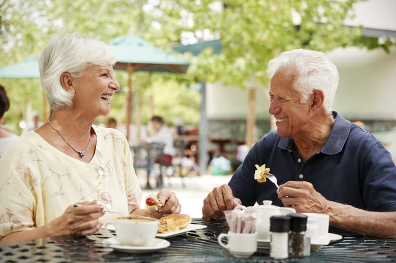 Senior Couple Enjoying Meal At Outdoor Cafe