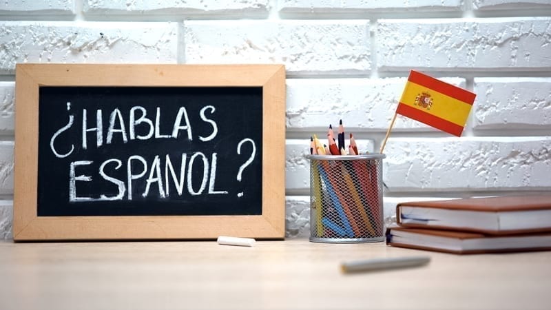 Do you speak Spanish written on board, international flag in box, language. 