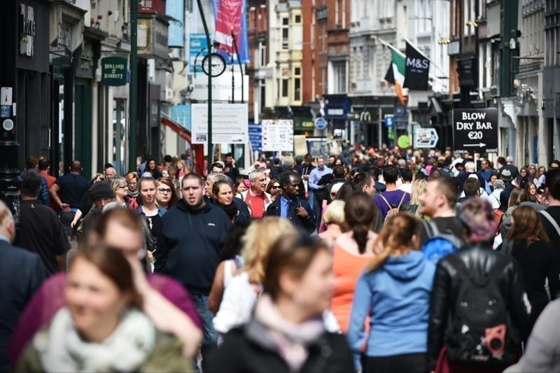 Crowds of people walk on Grafton Street, Ireland. 