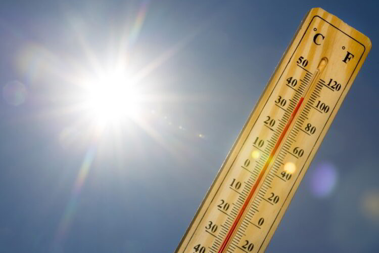 Mercury thermometer marking 39 degrees Celsius 100 Fahrenheit in a sunny day.