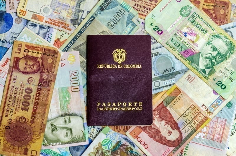 A Colombian Passport on top of colombian money