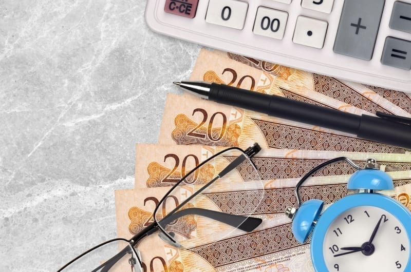 Dominican peso bills and calculator with glasses and pen, taxes in the dominican republic