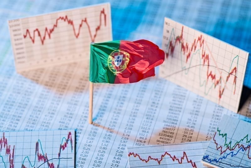 Portuguese flag with course tables and graphs on economic development. economy in portugal