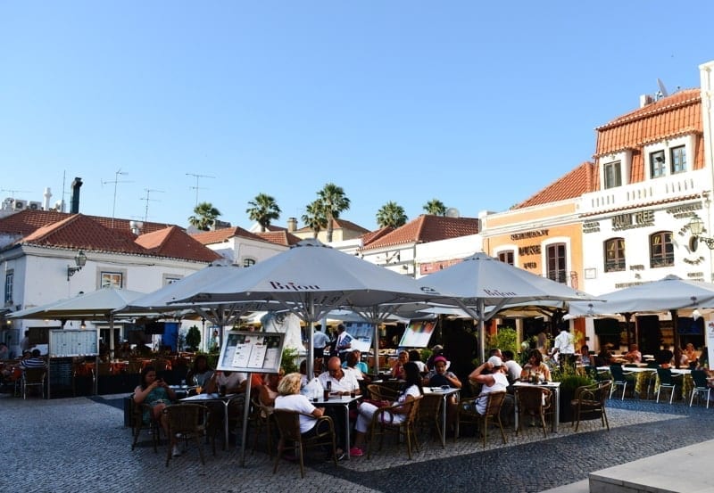 Tourist sitting in an outdoor café in Cascais, Portugal