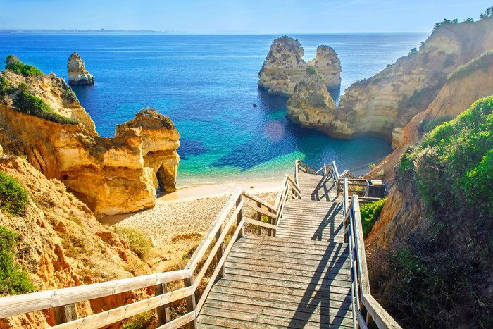Wooden footbridge to beautiful beach Praia do Camilo near Lagos. Algarve Portugal Retirement