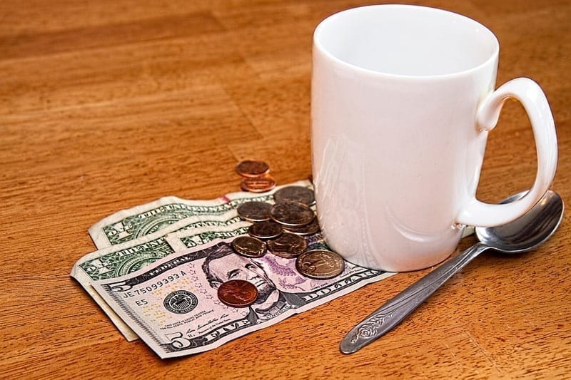 Coffee cup on counter with tip laying beside it.