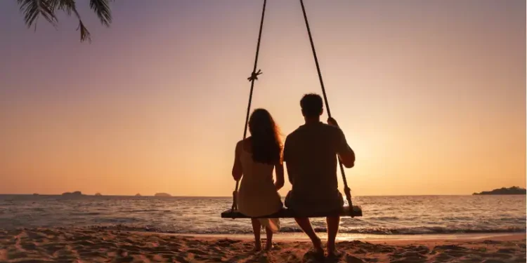 silhouette of romantic couple on sunset beach
