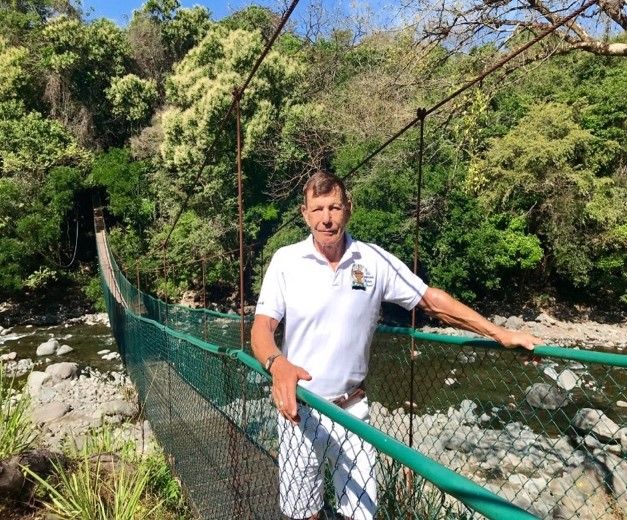 Frank Stegmeier standing on a brige over a river