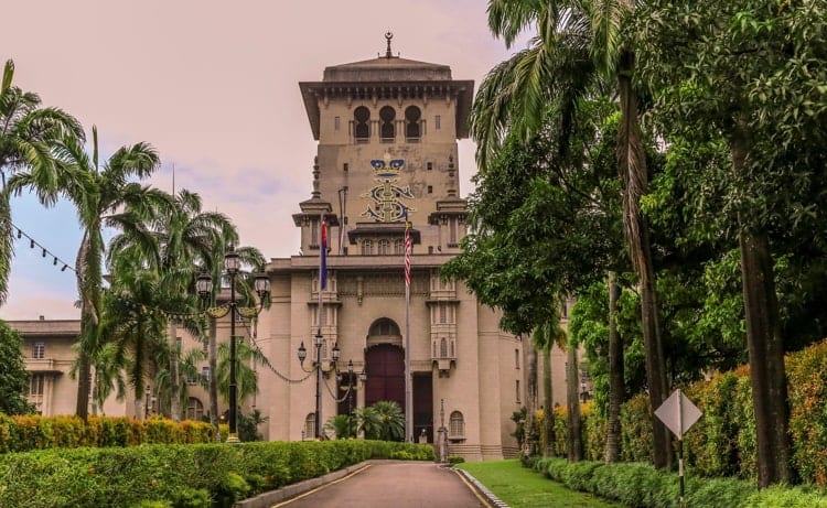 Surrounded by trees and shrubs the walkway leads to the Sultan Ibrahim Building in Johor Bahru Malaysia