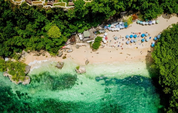 Tourists relax at the Padang Beach