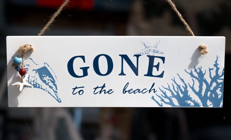 Gone to the beach sign hanging in shop door