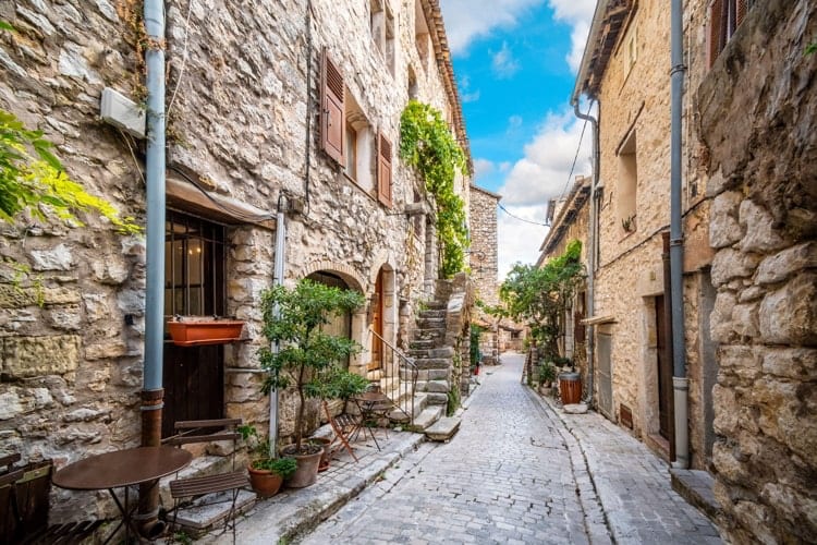 A picturesque back street of homes and apartments in the medieval village of Tourrettes Sur Loup in Southern France.