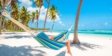 Woman relaxing on a hammock in Saona Island, Dominican Republic