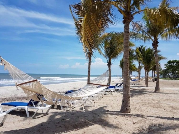 A white hammock in the white sand beach of Playa Caracol, Panama