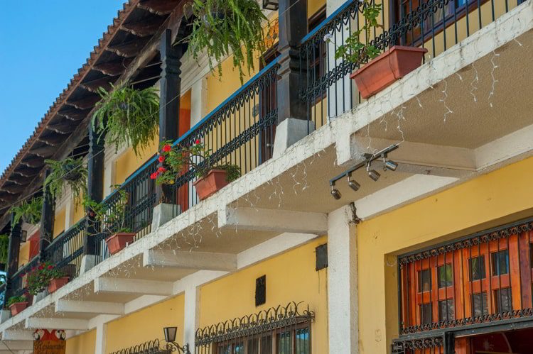 Detail of a colonial style house with a wrought iron balcony in the small city of Copan, Honduras