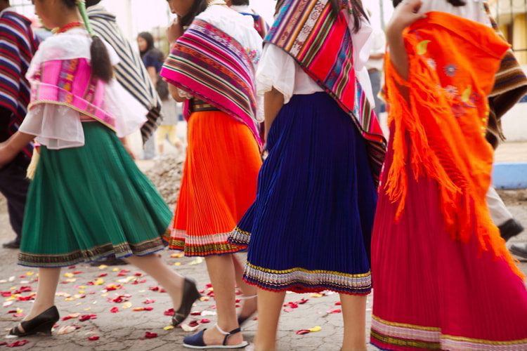 Colourful Highland dresses worn at a festival in Ambato, Cotopaxi Province, Ecuador