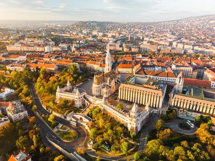 Aerial view of Fishermans Bastion and Matthias Church from above in Budapest during sunrise in autumn 