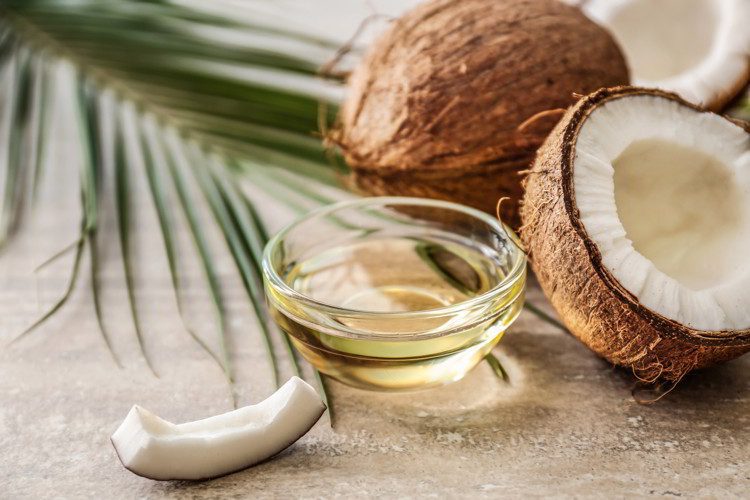 Bowl with coconut oil on table